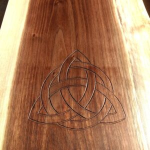 The carving of the Family Knot is set into a piece of Black Walnut