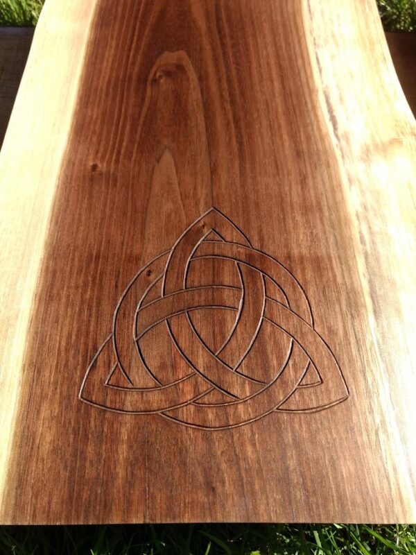 The carving of the Family Knot is set into a piece of Black Walnut