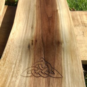 The carving of the tied Triquetra signifies the bonds to Celtic heritage and ancestry is set into a piece of Black Walnut