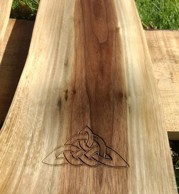 The carving of the tied Triquetra signifies the bonds to Celtic heritage and ancestry is set into a piece of Black Walnut