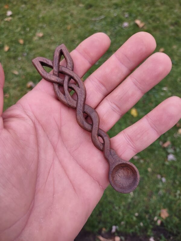 picture 2 of a celtic knot, hand carved from black walnut into a small spoon for incense powder