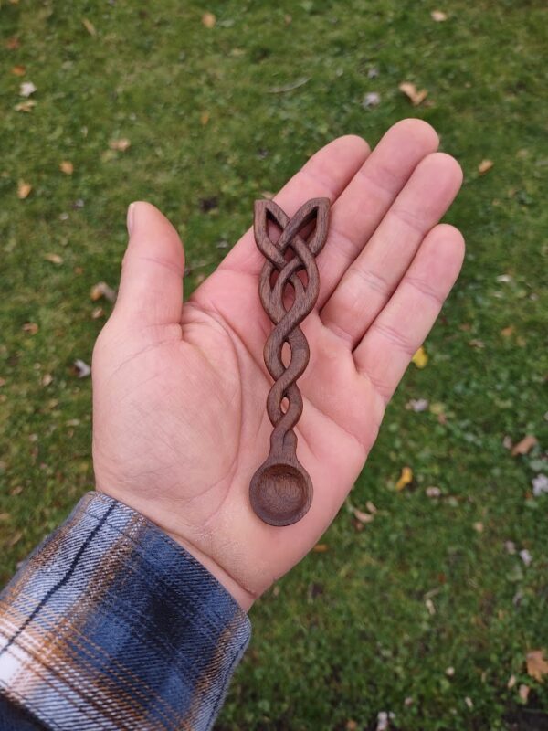 picture 1 of a celtic knot, hand carved from black walnut into a small spoon for incense powder